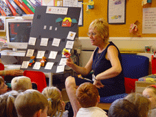 Teacher with class using puppets
